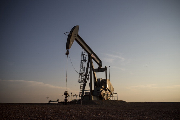 A pumpjack is seen on July 22, 2013 outside Williston, North Dakota. Pumpjacks are used to mechanically pump oil and natural gas out of the earth when there is not enough natural pressure for the liquids to rise on their own. (Photo by Andrew Burton/Getty Images)