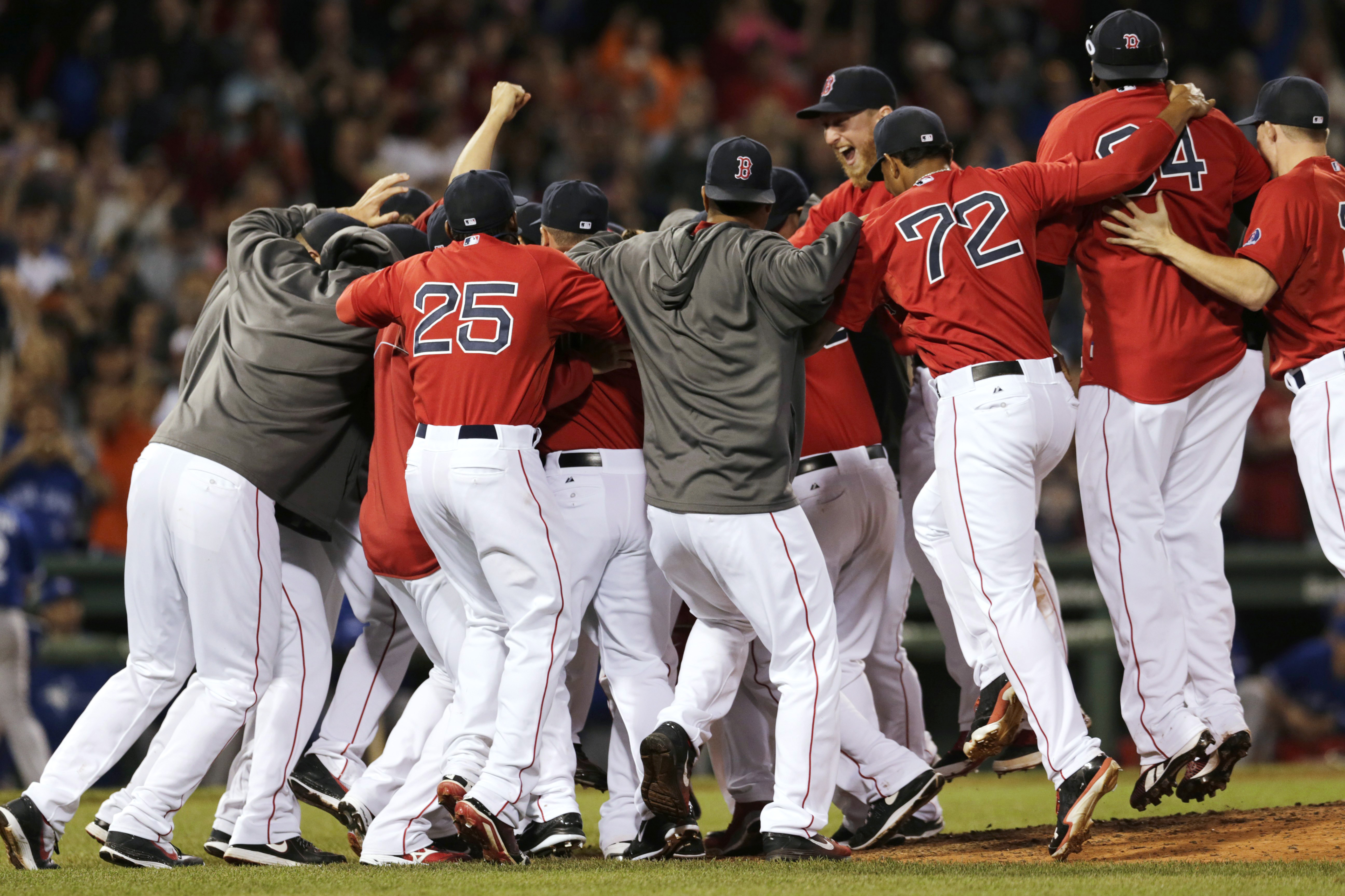 The Boston Red Sox celebrate after clinching the AL East with a 6-3 win over the Toronto Blue Jays in a baseball game at Fenway Park, Friday, Sept. 20, 2013, in Boston. (AP Photo/Charles Krupa)