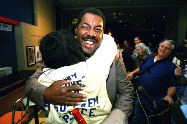 Jibreel Khazan, left, and Franklin McCain hug during the opening of an exhibit at the Smithsonian Institution's National Museum of American History in 1995  They joined Joseph McNeil to commemorate their sit-in at the Woolworth's lunch counter in 1960.  AP Photo/Tyler Mallory