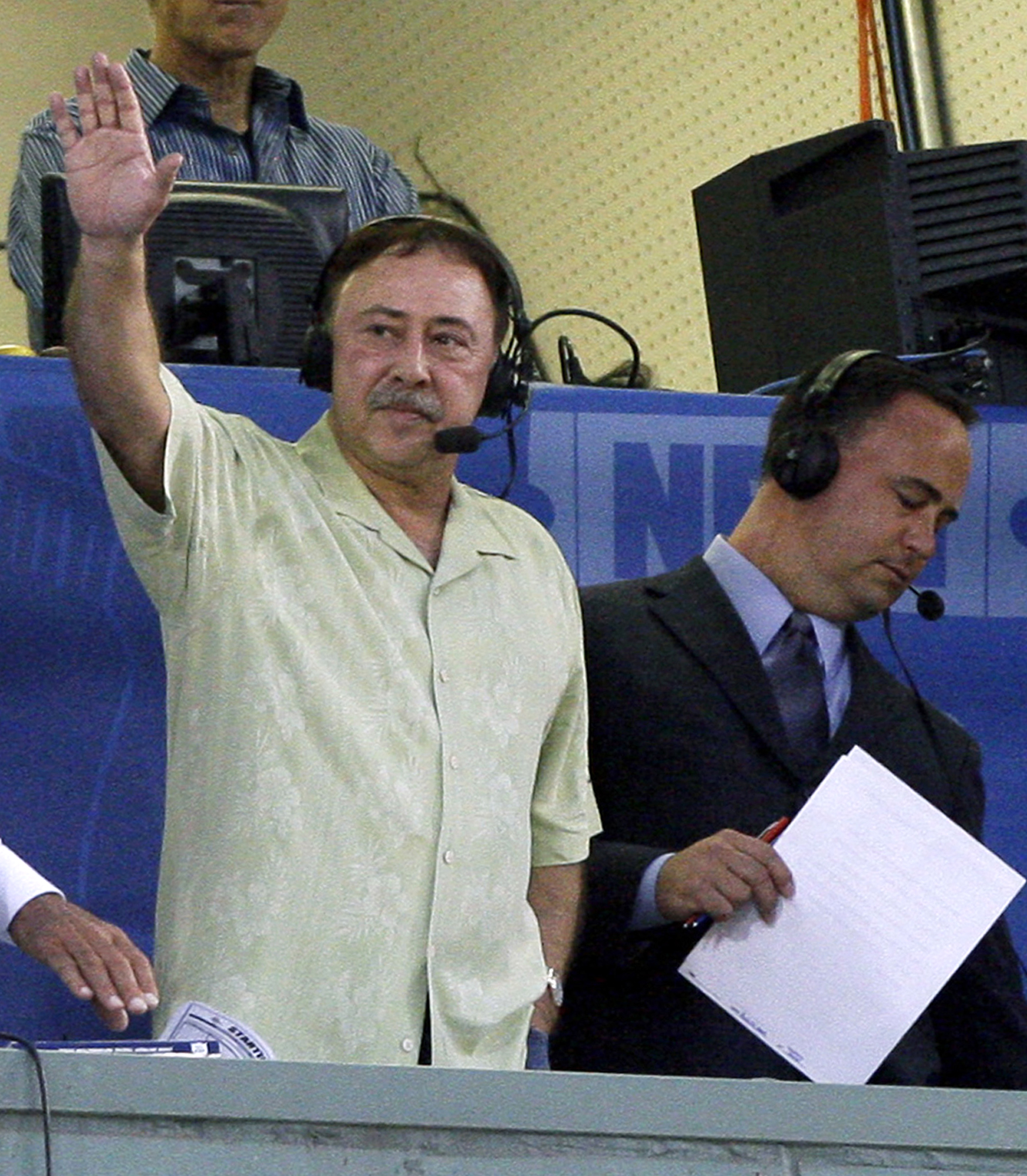 In this Aug. 12, 2009 file photo, Boston Red Sox announcer Jerry Remy waves to the crowd from the television broadcast booth at Fenway Park. AP Photo/Elise Amendola, File.