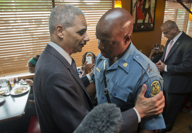 FLORRISSANT, MO - AUGUST 20:  U.S. Attorney General Eric Holder (L) talks with Capt. Ron Johnson, right, of the Missouri State Highway Patrol at Drake's Place Restaurant,August 20, 2014 in Florrissant, Missouri. Holder is traveling to Ferguson, Mo., to oversea the federal government's investigation into the shooting of 18-year-old Michael Brown by a police officer on Aug. 9th. Holder promised a "fair and thorough" investigation into the fatal shooting of a young blackman, Michael Brown, who was unarmed when a white police officer shot him multiple times. (Photo by Pablo Martinez Monsivais-Pool/Getty Images)