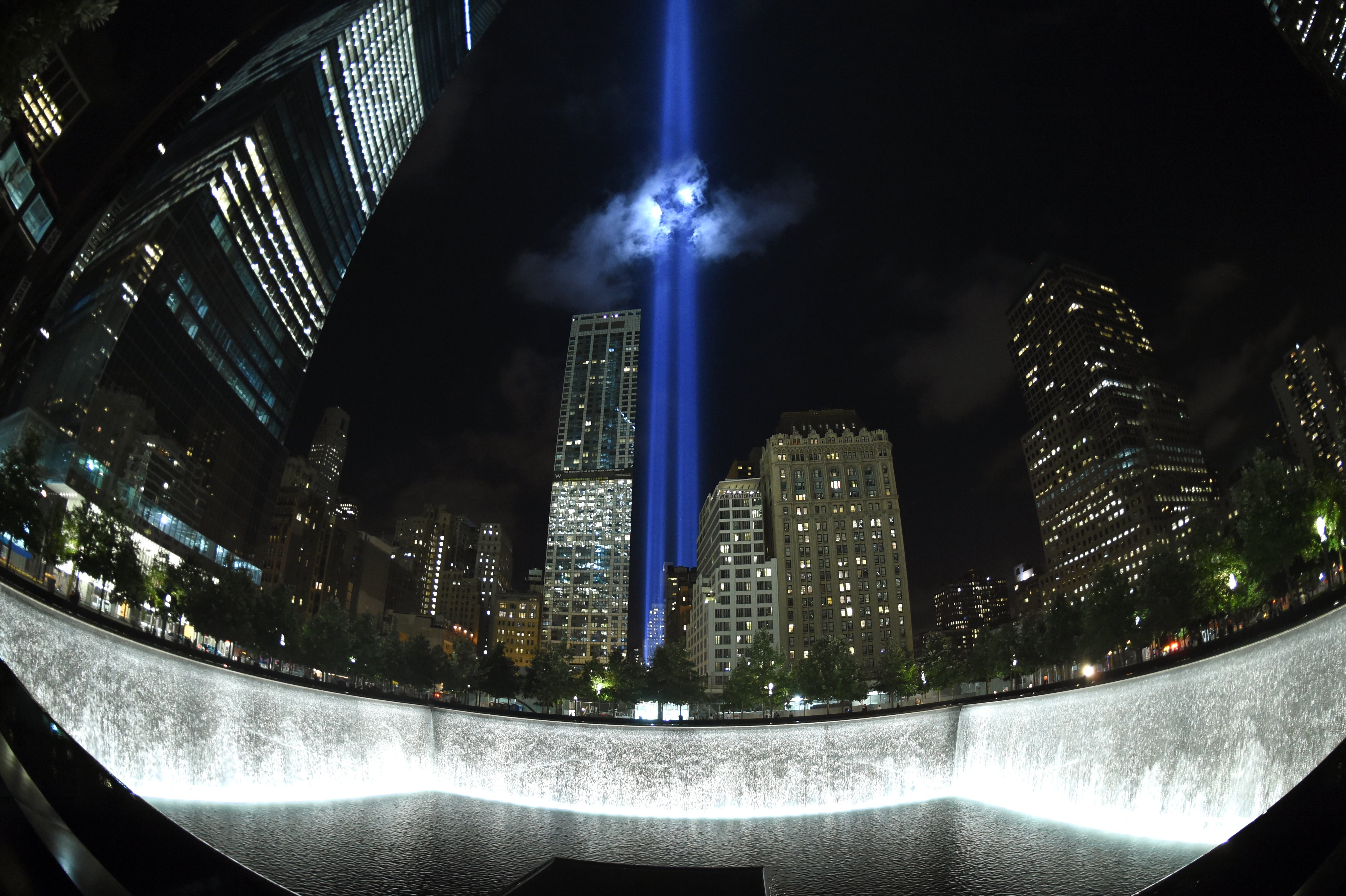 The Tribute in Light illuminates the sky  behind the  9/11 Memorial waterfalls and reflecting pool in New York on September 10, 2014 marking the 13th anniversary of the September 11, 2001 attacks. The tribute, an art installation of the Municipal Art Society, consists of 88 searchlights placed next to the site of the World Trade Center creating two vertical columns of light in remembrance of the 2001 attacks.  Photo: Timothy A. Clary/AFP/Getty Images.