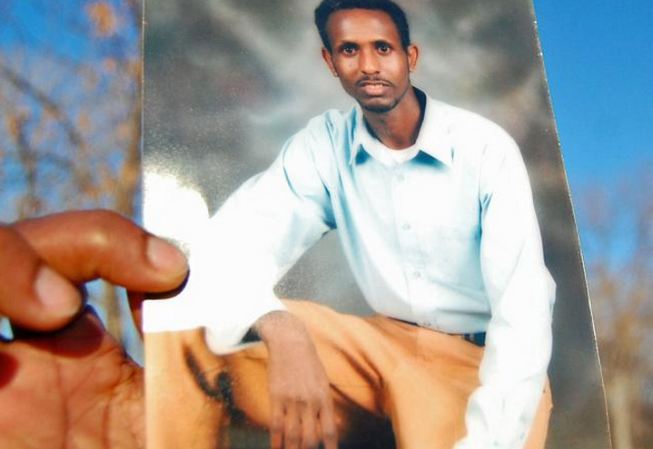 At mourner held a photo of Mohamed "Mahad" Warfa, 30, of Savage, at his funeral in 2010. MPR Photo/Tim Post/File.