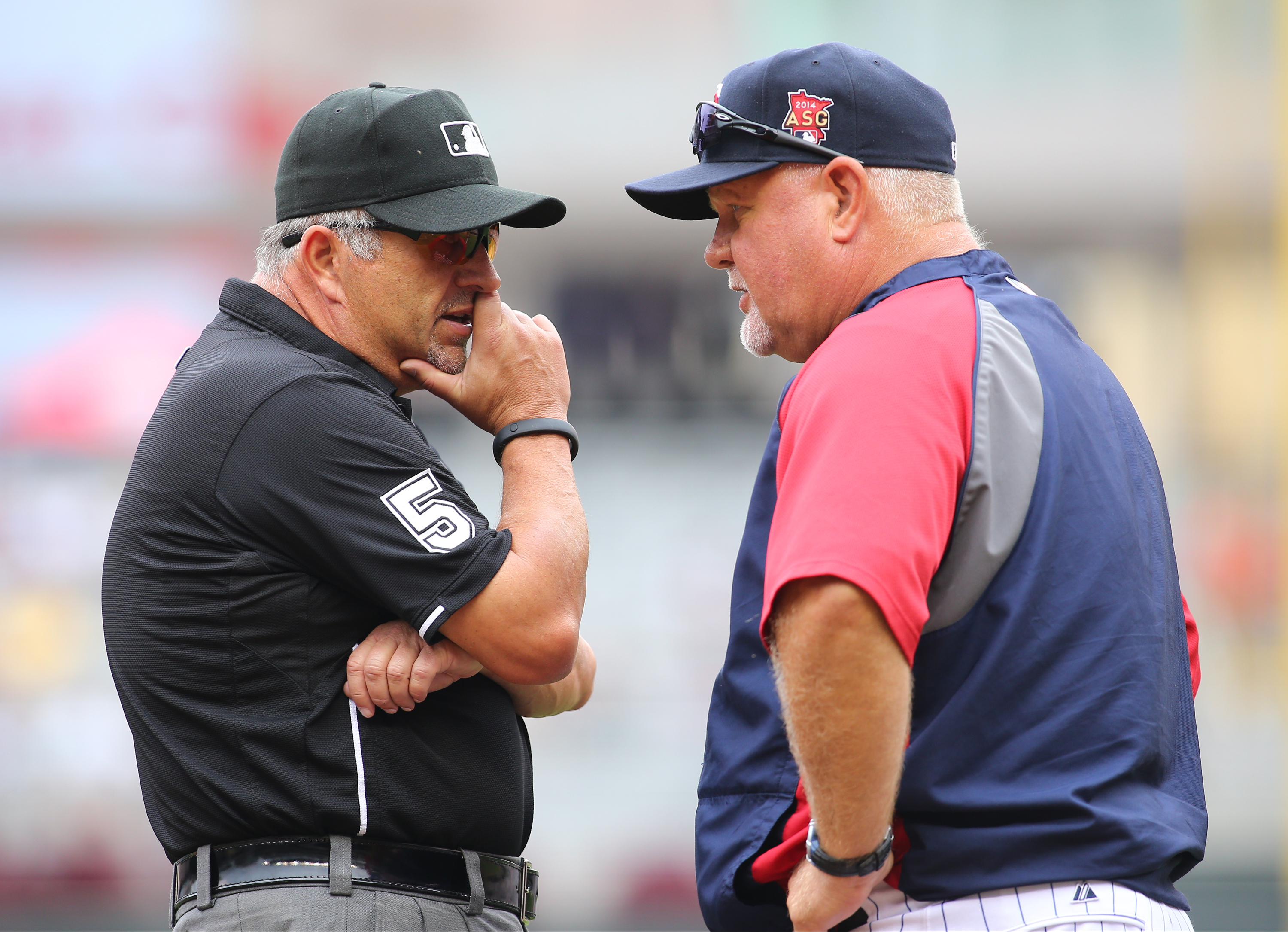 Umpire Dale Scott talks with then manager Ron Gardenhire  in August.  Photo: Adam Bettcher/Getty Images.