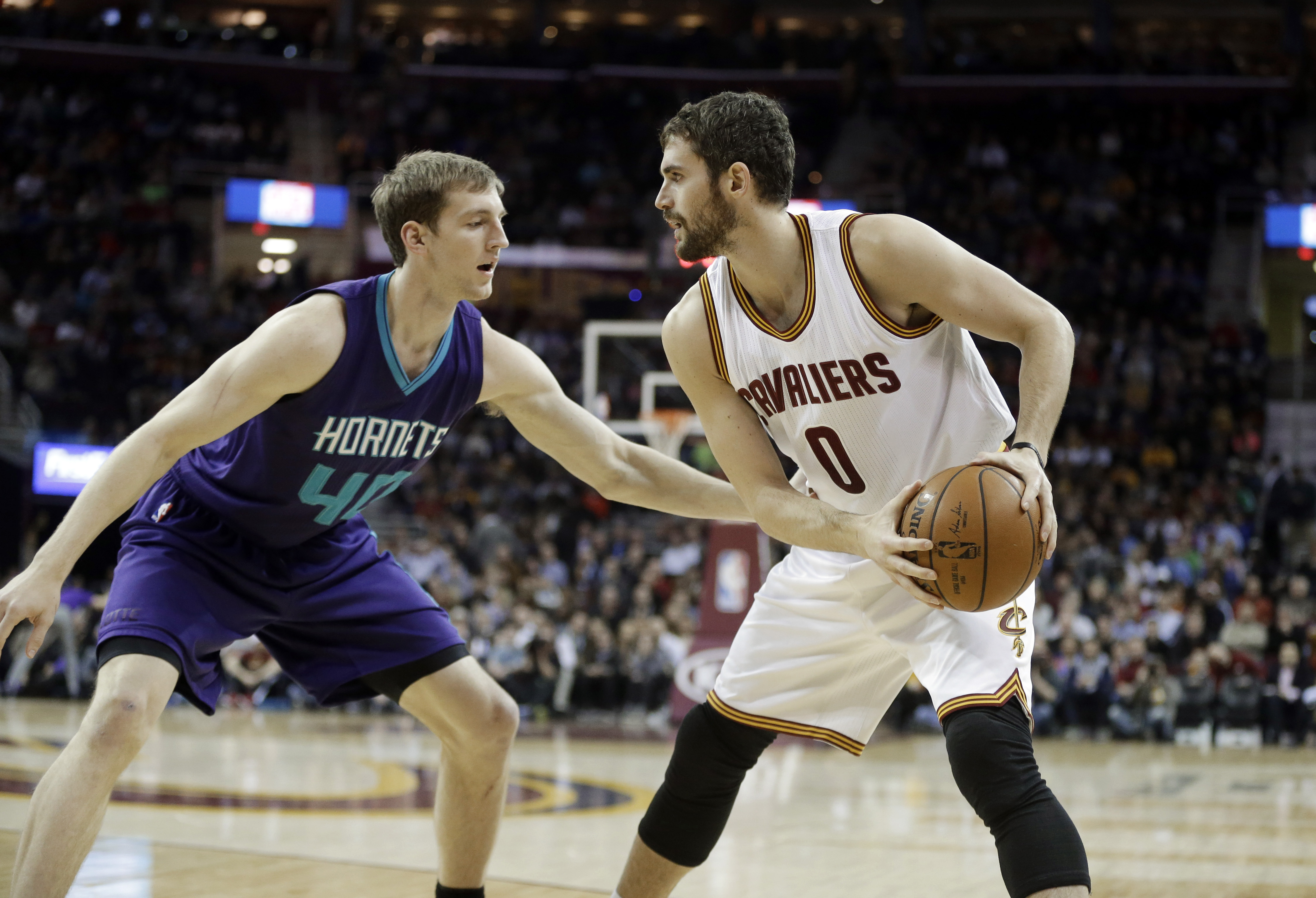 Cleveland Cavaliers' Kevin Love (0) sizes up Charlotte Hornets' Cody Zeller in an NBA basketball game last week  in Cleveland.  AP Photo/Mark Duncan.