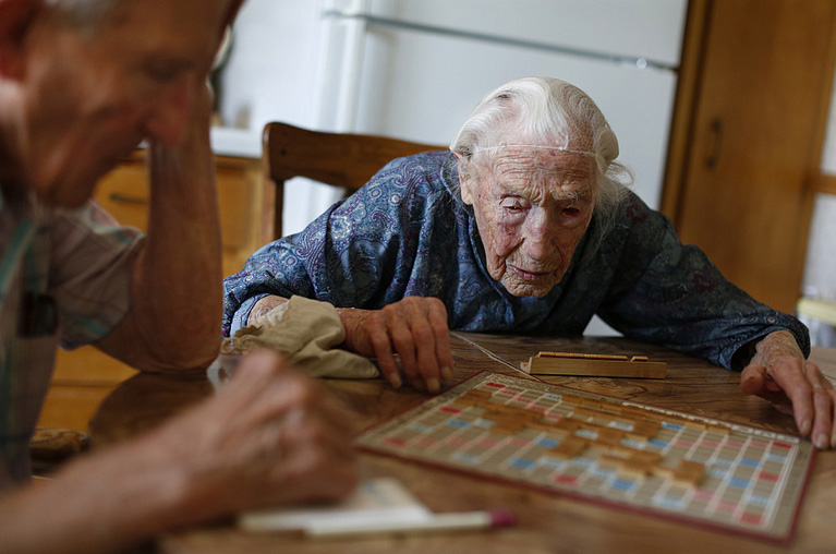 At her home in Pottsdam, Minn., Anna Stoehr plays Scrabble with her son Harlan, 83, May 16, 2012. Richard Tsong-Taatarii / Star Tribune via AP