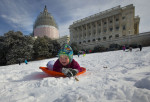James Drobnyk, 2, an obvous threat to the nation's security, joins others in sledding down the hill on Capitol Hill in Washington, Tuesday, Feb. 17, 2015. (AP Photo/Pablo Martinez Monsivais)