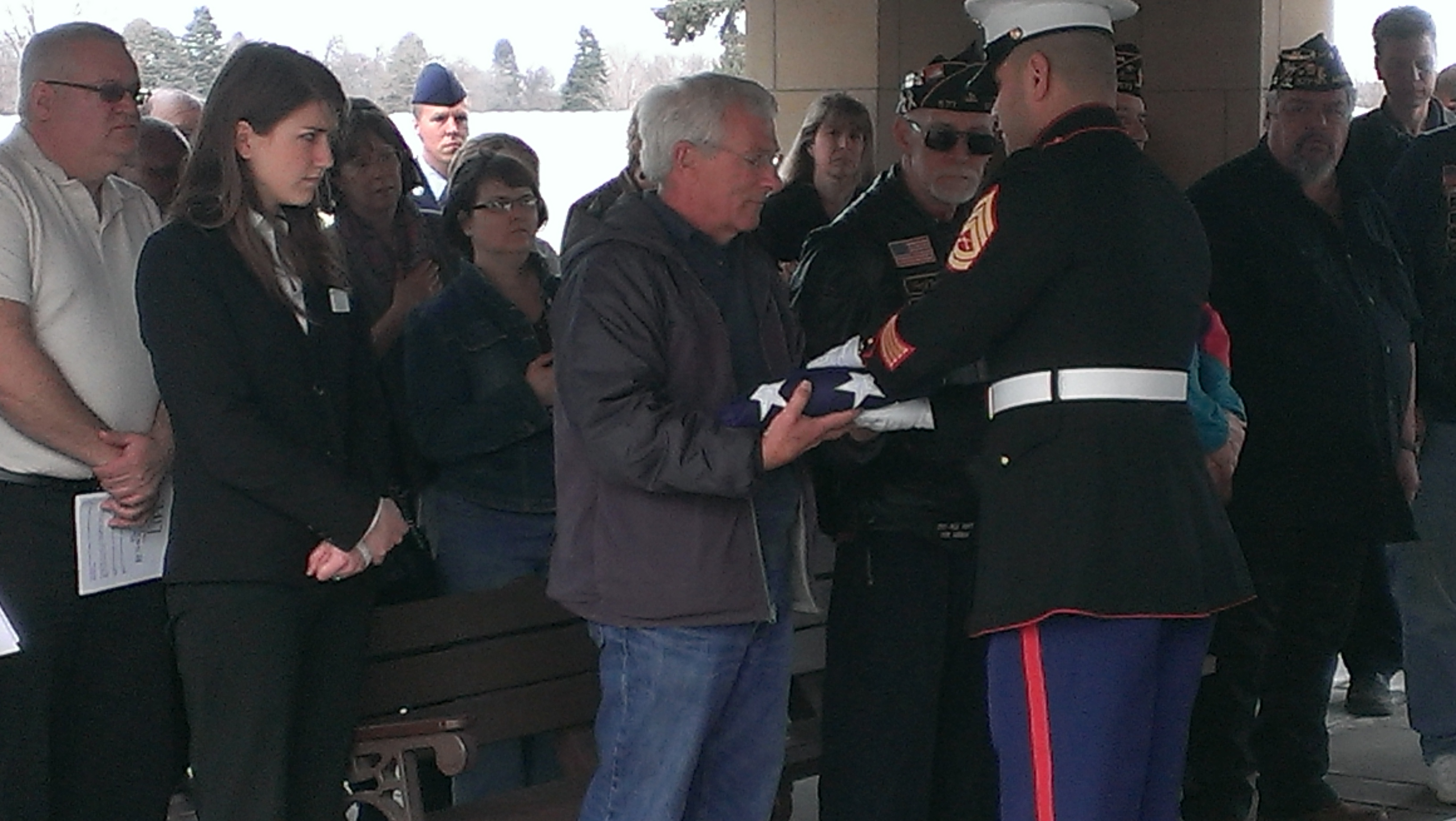A Marine officer presents an American flag to Donald Jackson. It had draped the casket of his brother, Jerome.  Photo: Bob Collins/Minnesota Public Radio News
