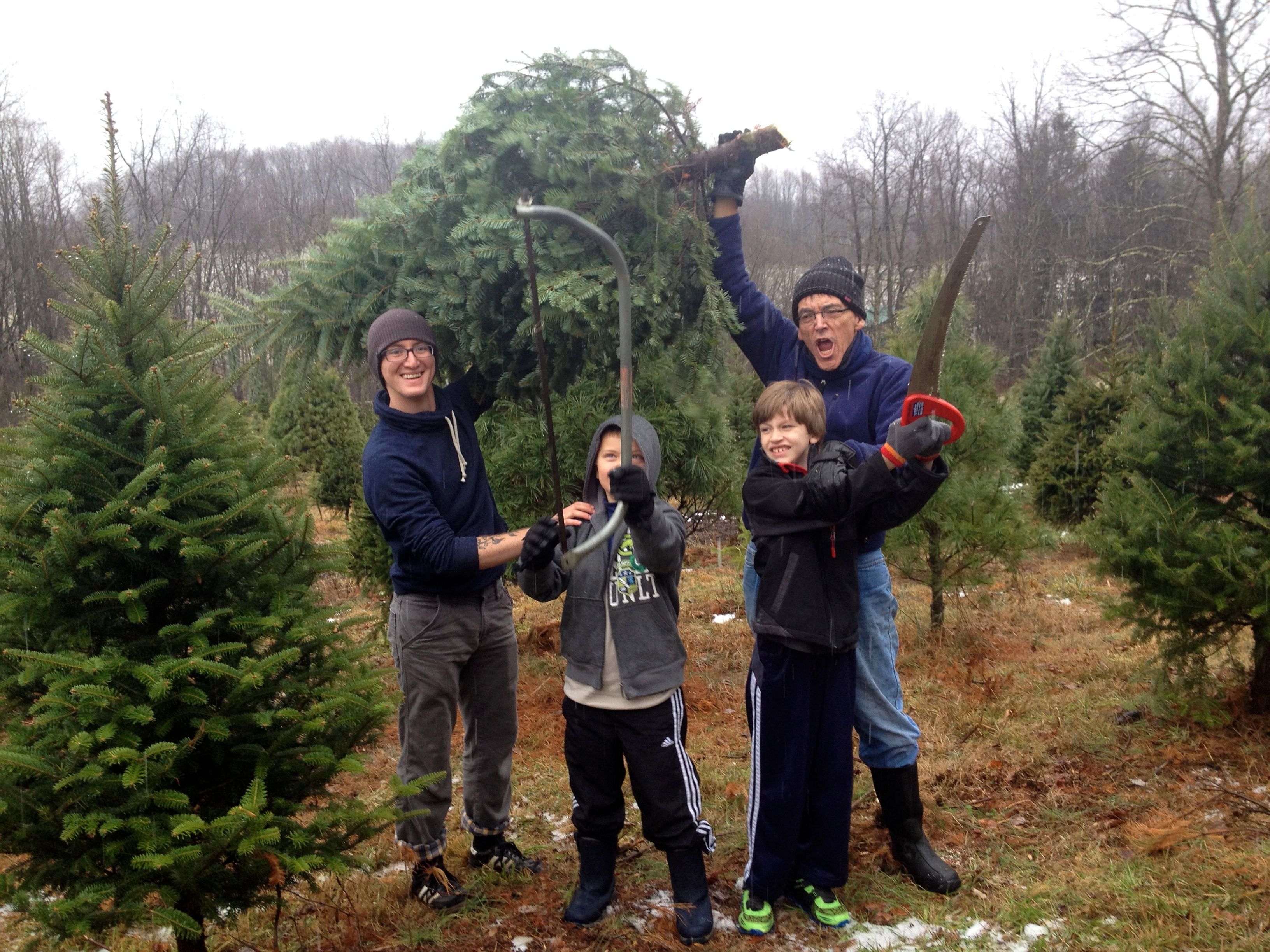 Cutting down a Christmas tree with son-in-law Skyelar Bowmar, Jon Beeson, 9, and Joel Beeson, 7, December, 2013. (Photo courtesy of Joel Beeson)