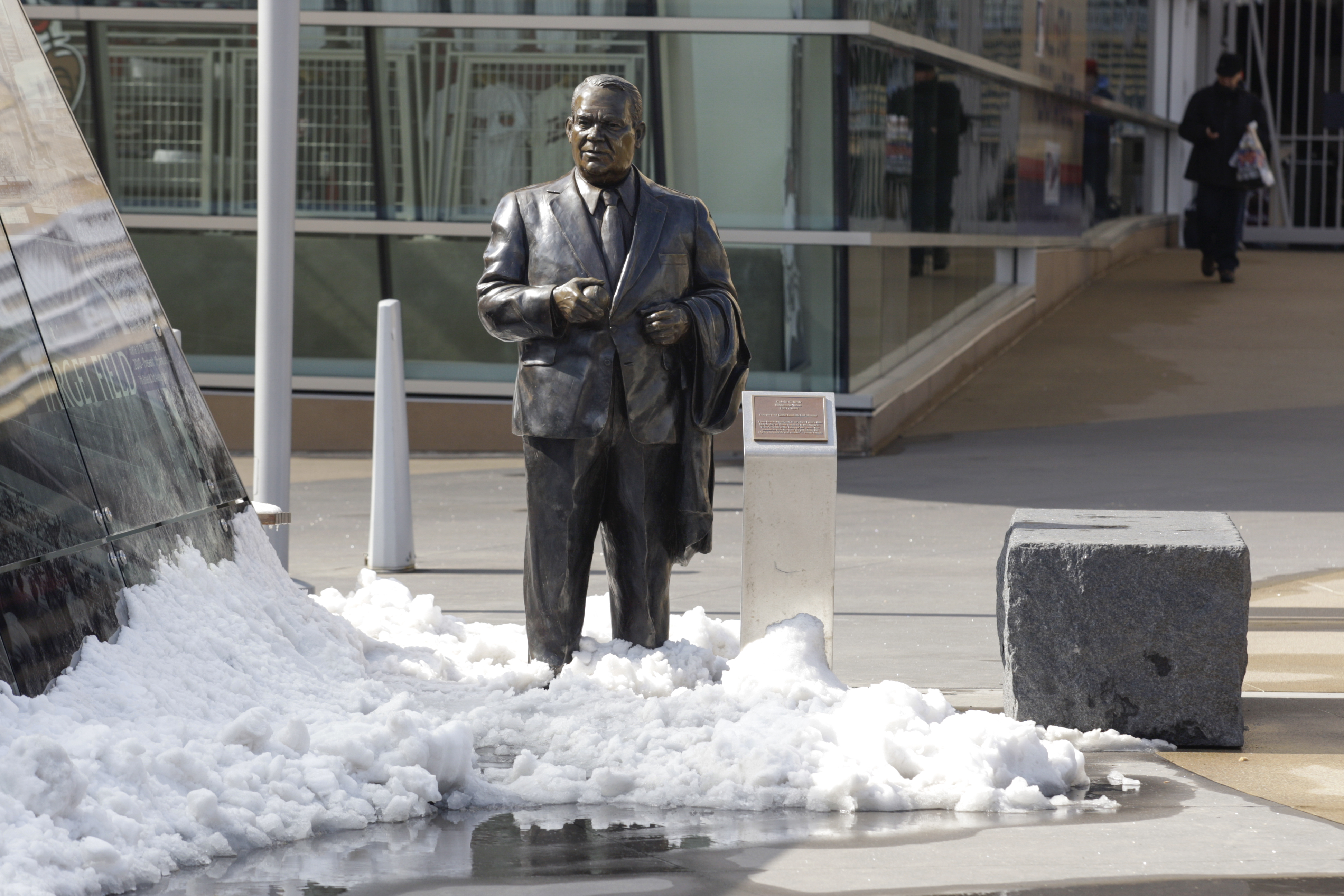 A statue of former Twins' owner Calvin Griffith stands in the snow outside Target Field before a baseball game between the Minnesota Twins and the Toronto Blue Jays, Thursday, April 17, 2014, in Minneapolis. (AP Photo/Paul Battaglia)