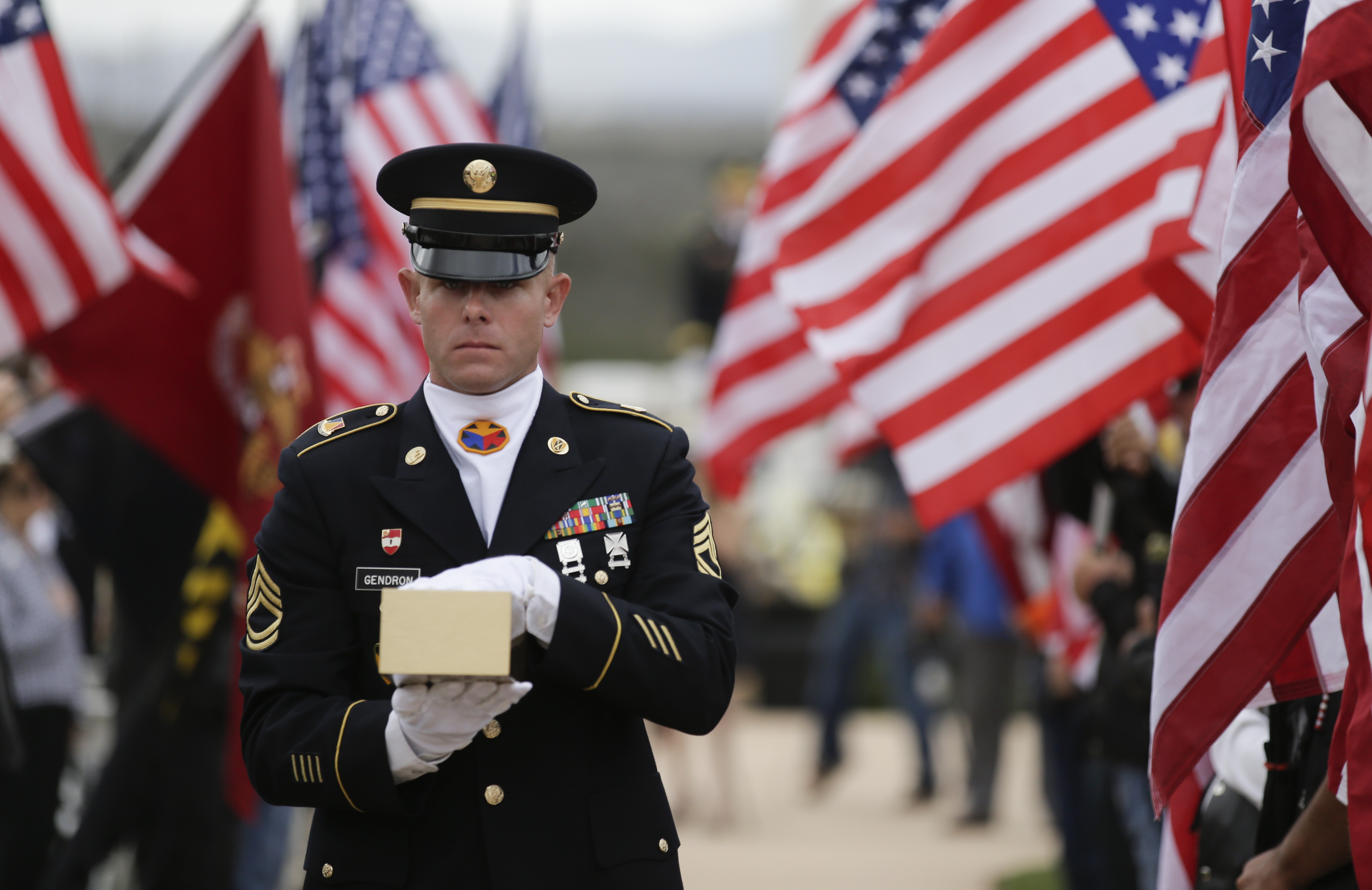 Army Sgt. 1st Class Joshua Gendron carries the remains of Army Sgt. Charles Schroeter, who was awarded the Congressional Medal of Honor for gallantry in an 1869 battle during the Indian Wars during a service with full military honors at Miramar National Cemetery Thursday, July 9, 2015 in San Diego. Schroeter’s remains were located only recently, when the Congressional Medal of Honor Historical Society traced them to San Diego’s Greenwood Memorial Park, where they had rested since 1921.  The remains were interred in an unmarked crypt, along with other unclaimed remains. (AP Photo/Chris Carlson)