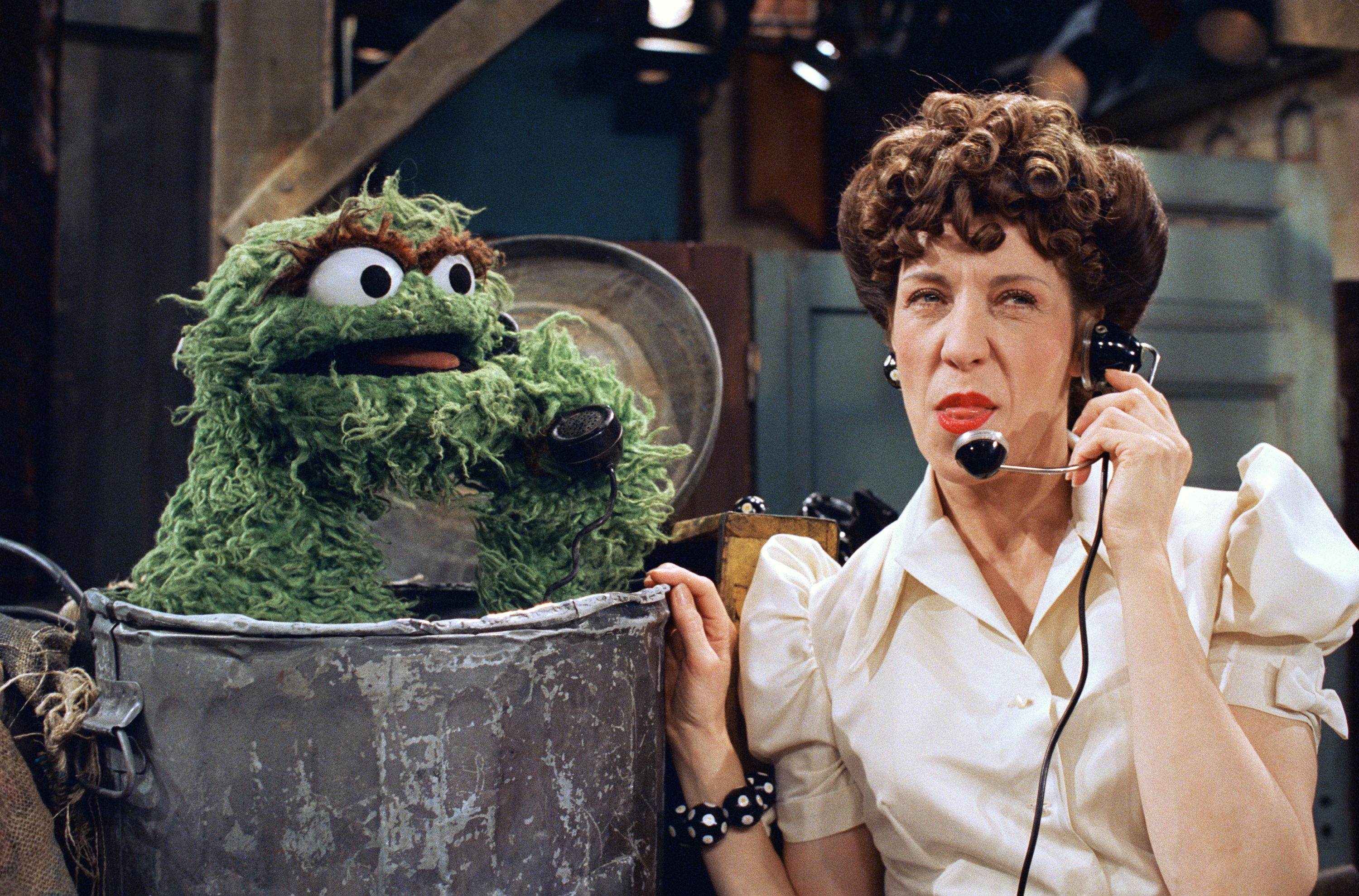 Lily Tomlin plays “Ernestine” the telephone operator in a skit with Oscar the grouch when she appeared on the TV Show “Sesame Street” in New York on Sept. 19, 1988. (AP Photo/Marty Lederhandler)