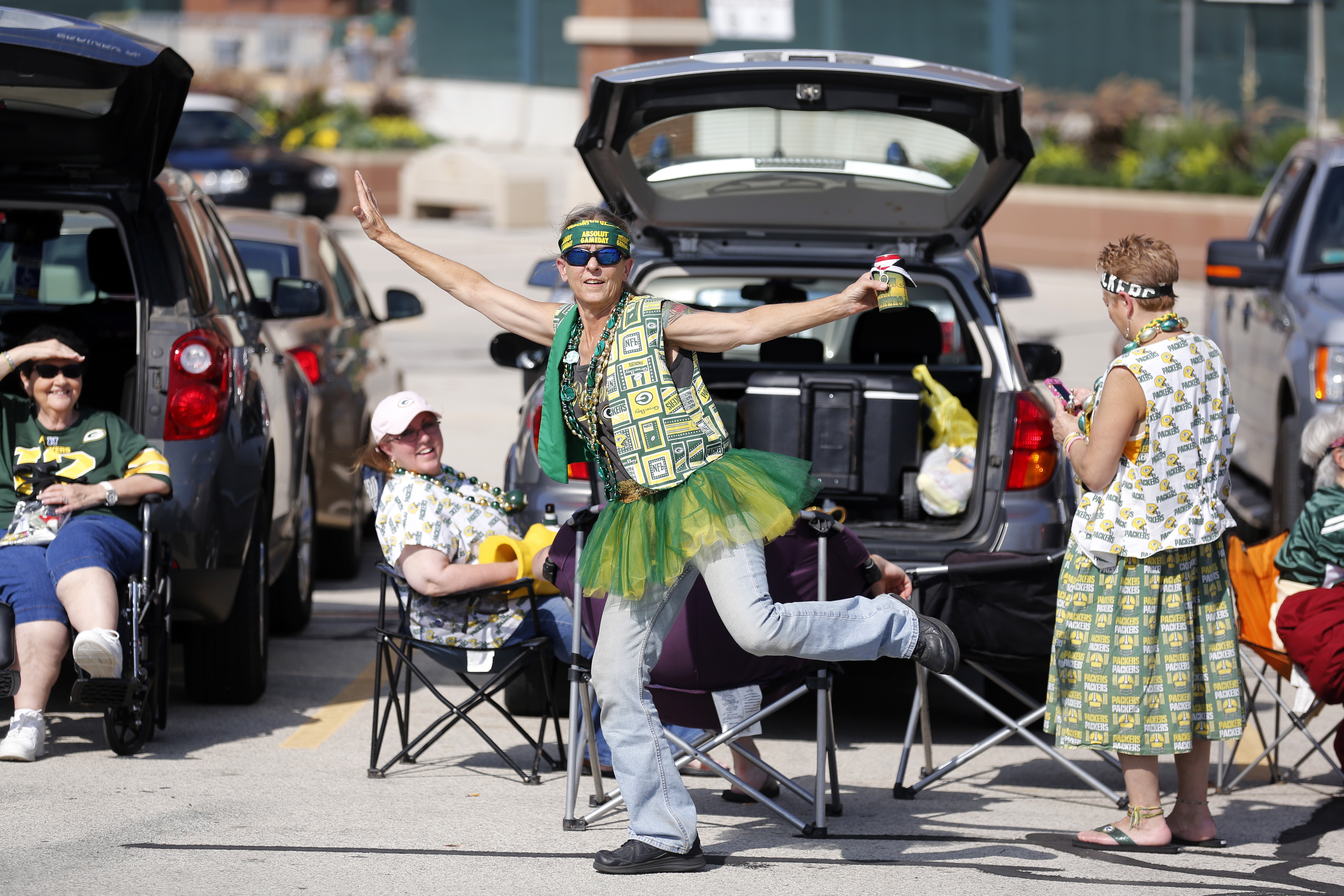 Fans tailgate before a preseason NFL football game between the Green Bay Packers and the New Orleans Saints Thursday, Sept. 3, 2015, in Green Bay, Wis. (AP Photo/Jeffrey Phelps)