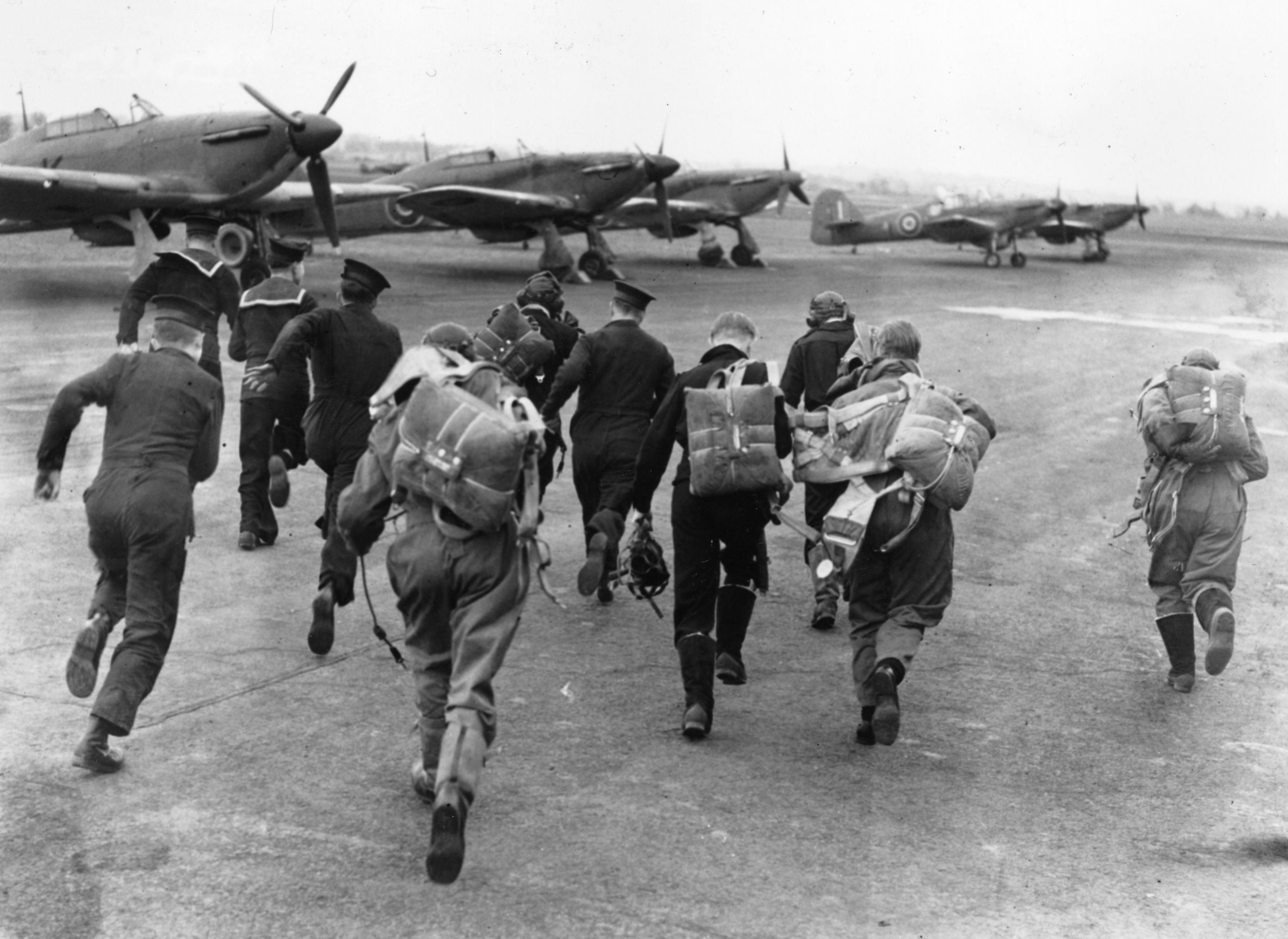 A group of RAF pilots and sailors scramble for their planes during an alert at a training centre for the Fleet Air Arm. (Photo by Keystone/Getty Images)