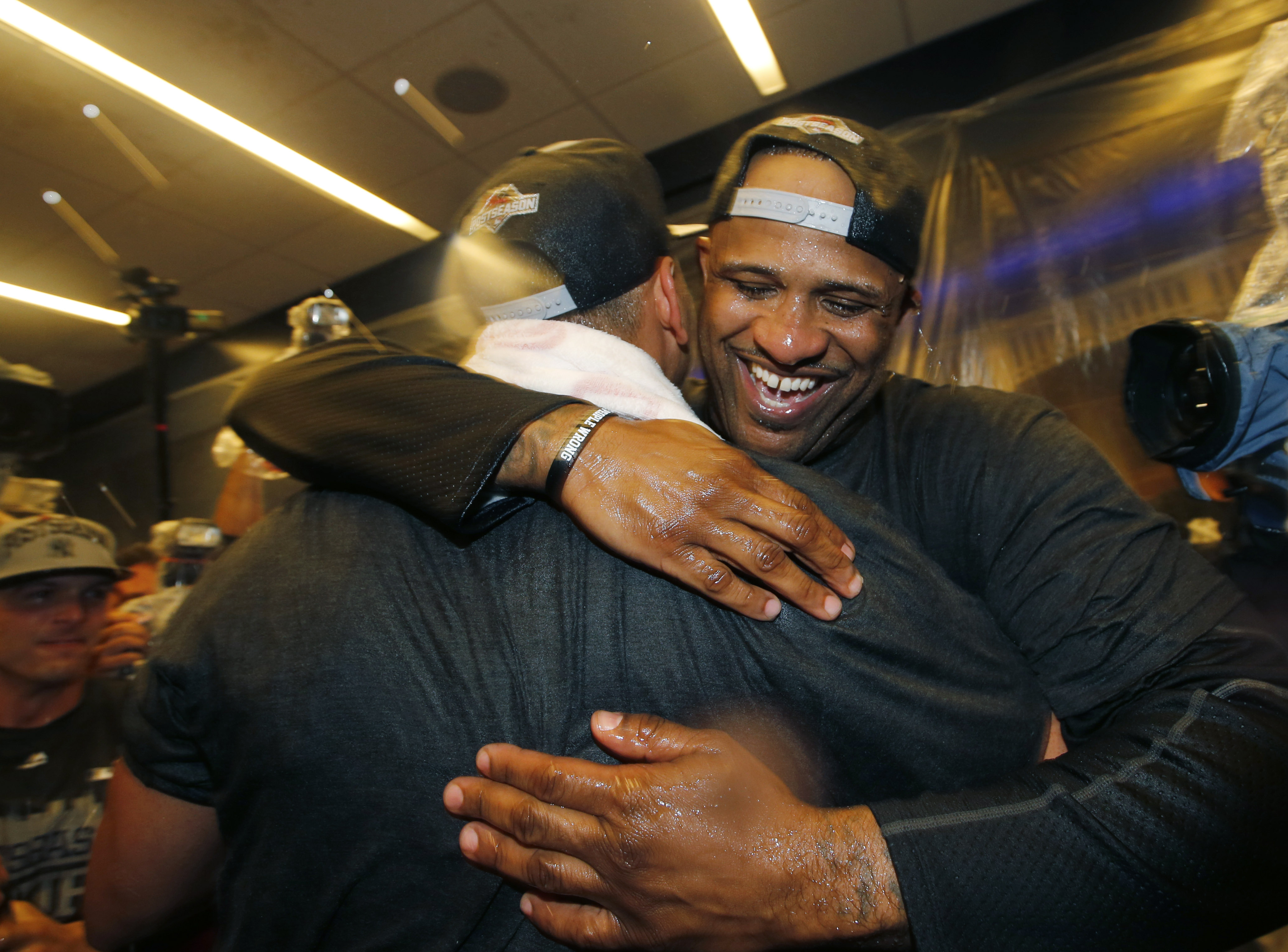 New York Yankees starting pitcher CC Sabathia (52) embraces a teammate after he helped the Yankees clinch a wild card berth in the playoffs after the Yankees defeated the Boston Red Sox 4-1 in a baseball game in New York, Thursday, Oct. 1, 2015.   (AP Photo/Kathy Willens)