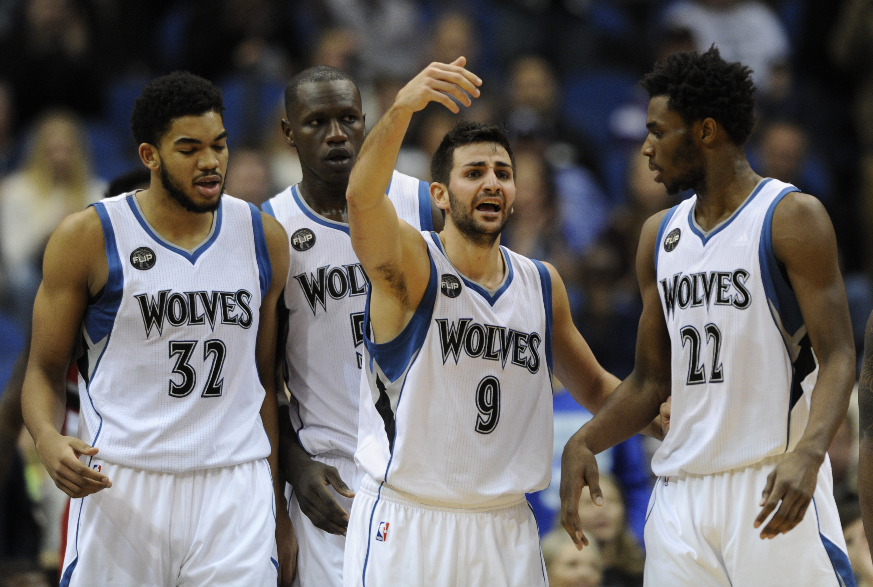 Minnesota Timberwolves center Karl-Anthony Towns (32), left, center Gorgui Dieng (5), of Senegal, guard Ricky Rubio (9), of Spain, and guard Andrew Wiggins (22) huddle up during the fourth quarter of an NBA basketball game against the Portland Trail Blazers on Saturday, Dec. 5, 2015, in Minneapolis. (AP Photo/Hannah Foslien)