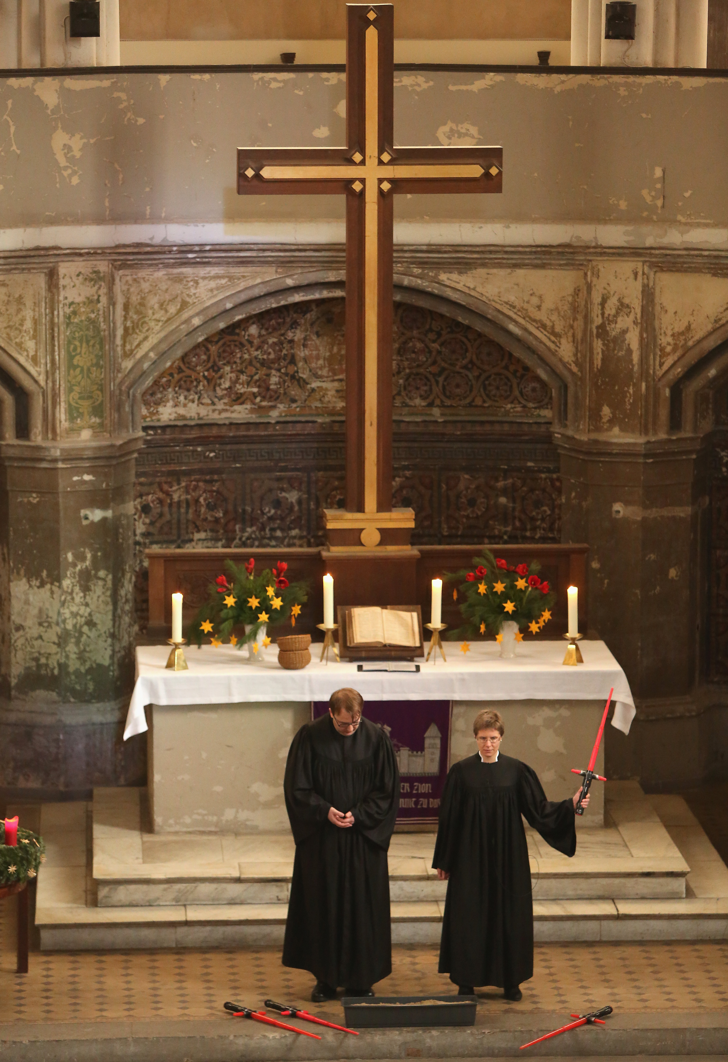 BERLIN, GERMANY - DECEMBER 20:  Vicars Lucas Ludewig (L) and Ulrike Garve hold a church service centered around the 1983 film 'Star Wars Episode VI: Return of the Jedi' at the Zionskirche (Zion Church) on December 20, 2015 in Berlin, Germany. The latest Star Wars film, 'Star Wars Episode VII: The Force Awakens,' was released in the country two days earlier, and local priests used the opportunity to tie Biblical parallels concerning good and evil to the movie, while using the original film's score by John Williams as organ accompaniment, along with video clips.  (Photo by Adam Berry/Getty Images)