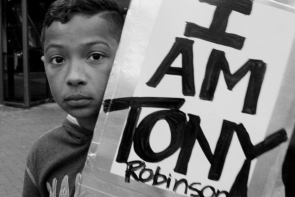 Dyvonte Clinton stood with a sign shortly before participating in a downtown Minneapolis protest, Wednesday, May 13, 2015. Courtesy Susan Montgomery