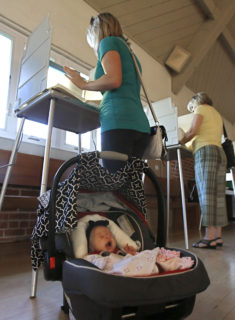 Melody Longacre, 10 weeks, yawns as she waits for her mother, Holly Longacre to mark her ballot during California's primary election Tuesday, June 7, 2016, in Sacramento, Calif. Attorney General Kamala Harris and fellow Democrat, U.S. Rep. Loretta Sanchez are the top two candidates for California's first open U.S. Senate seat in 24 years and  will advance to a runoff election in November to replace the retiring Barbara Boxer. Attorney General Kamala Harris is a heavy favorite and a fellow Democrat, U.S. Rep. Loretta Sanchez, is looking to hold off three Republican challengers for second place.(AP Photo/Rich Pedroncelli)