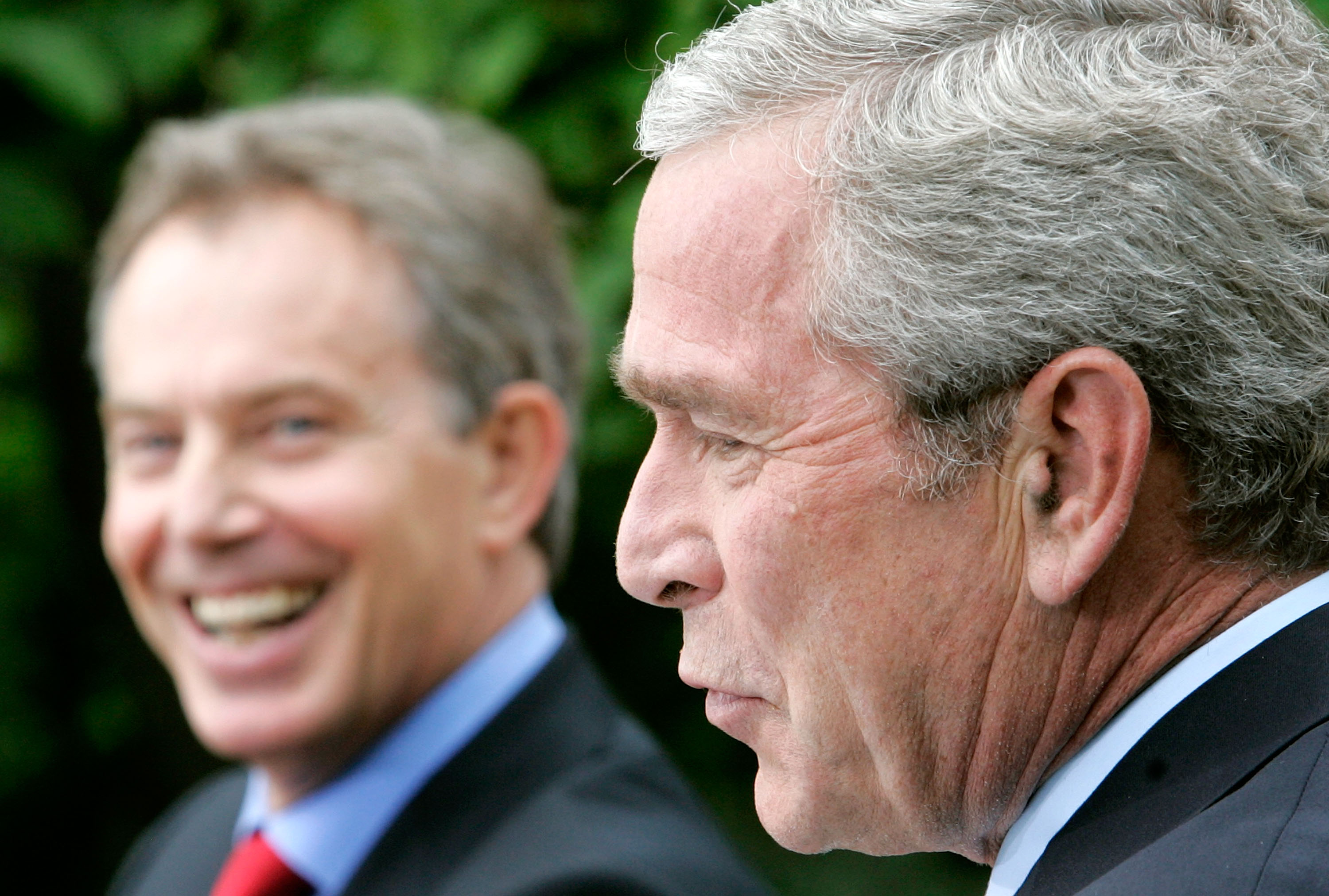  British Prime Minister Tony Blair (L) laughs as U.S. President George W. Bush speaks at a news conference in the Rose Garden of the White House May 17, 2007.  (Photo by Mark Wilson/Getty Images)
