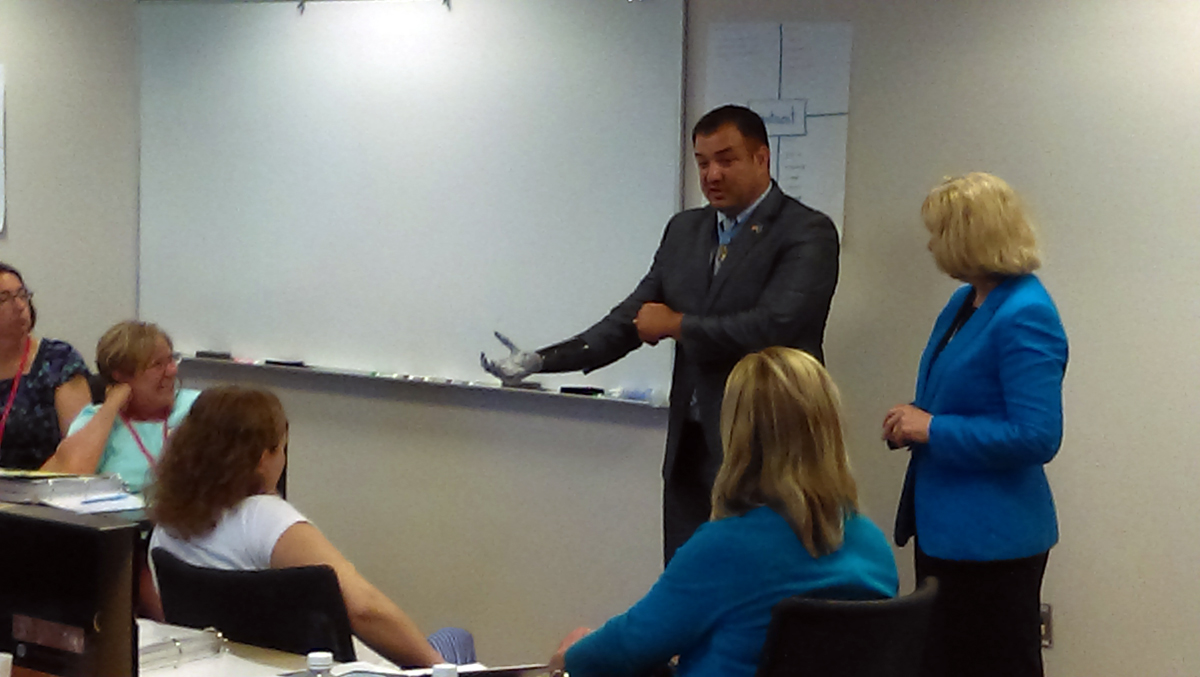 Sgt. Leroy Petry shows his ‘robotic hand’ to a group of Minnesota teachers who are developing a citizenship curriculum based on the values enshrined in the Medal of Honor, which Sgt. Petry received in 2011. Photo: Bob Collins/MPR News