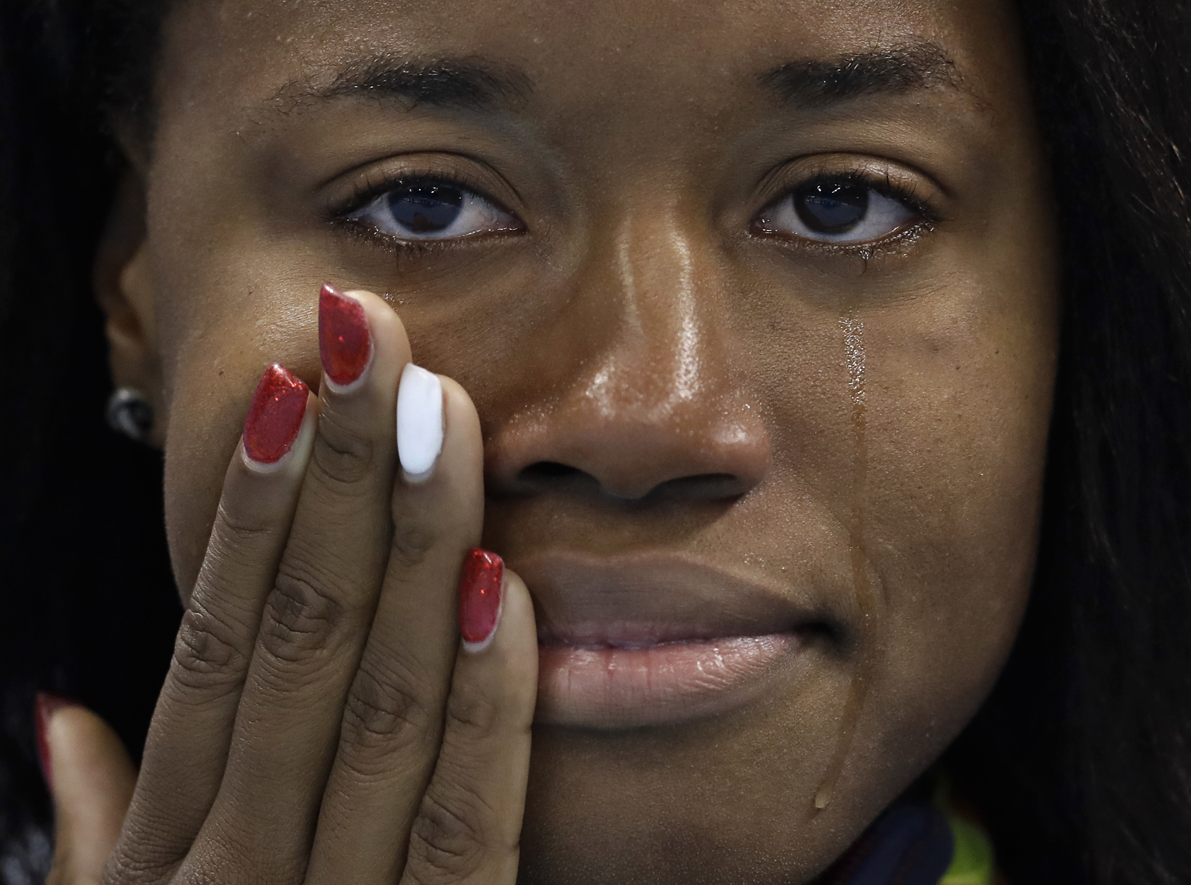 United States' gold medal winner Simone Manuel cries during the medal ceremony for the women's 100-meter freestyle final during the swimming competitions at the 2016 Summer Olympics, Friday, Aug. 12, 2016, in Rio de Janeiro, Brazil. (AP Photo/Michael Sohn)