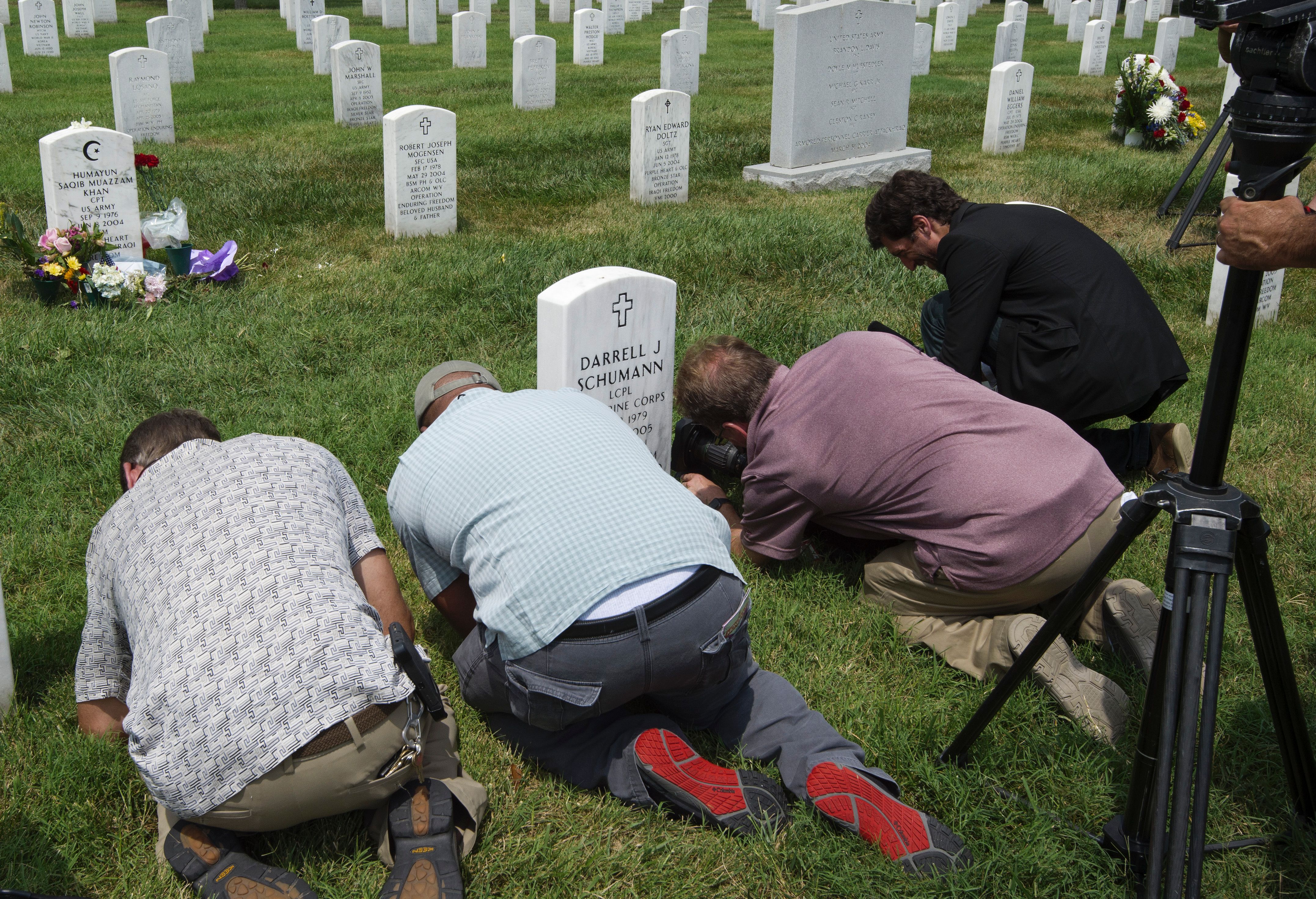 TV cameramen take video of the grave marker(Top-L) for US Army Captain Humayun Saqib Muazzam Khan August 1, 2016, in Section 60 of Arlington National Cemetery in Arlington, Virginia. Photo: Paul J. Richards/AFP/Getty Images.