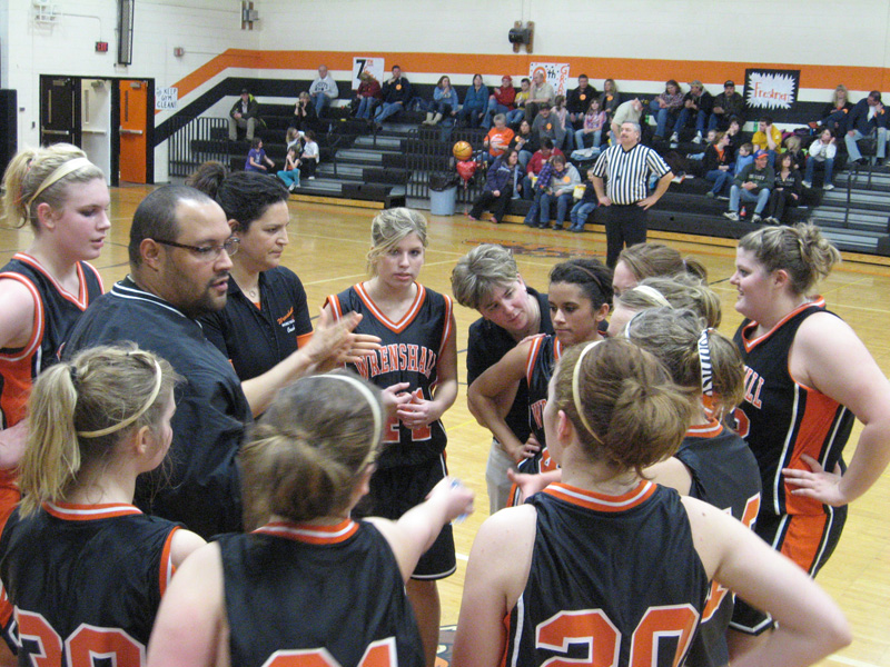 The Wrenshall girls basketball team huddled up in the middle of another loss in 2010. Photo: Bob Collins | MPR News