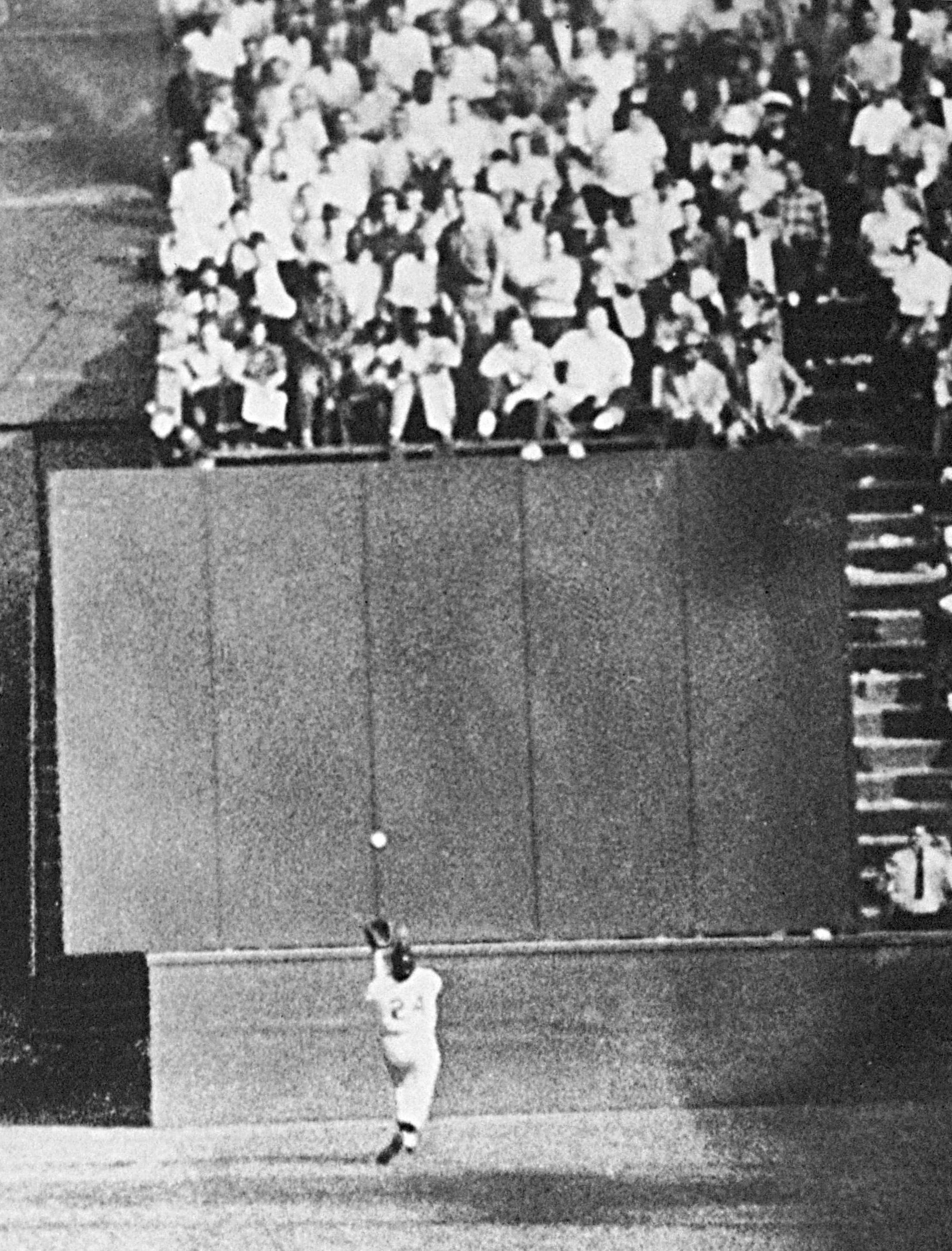  In this Sept. 29, 1954, file photo, New York Giants center fielder Willie Mays, running at top speed with his back to the plate, gets under a 450-foot blast off the bat of Cleveland Indians first baseman Vic Wertz to pull the ball down in front of the bleachers wall in the eighth inning of Game 1 of the World Series at the Polo Grounds in New York. After setting a then-American League record with 111 victories, Cleveland was swept by the Giants in a World Series best known for Mays' amazing over-the-shoulder catch, a highlight that still taunts the Indians to this day. (AP Photo, File)