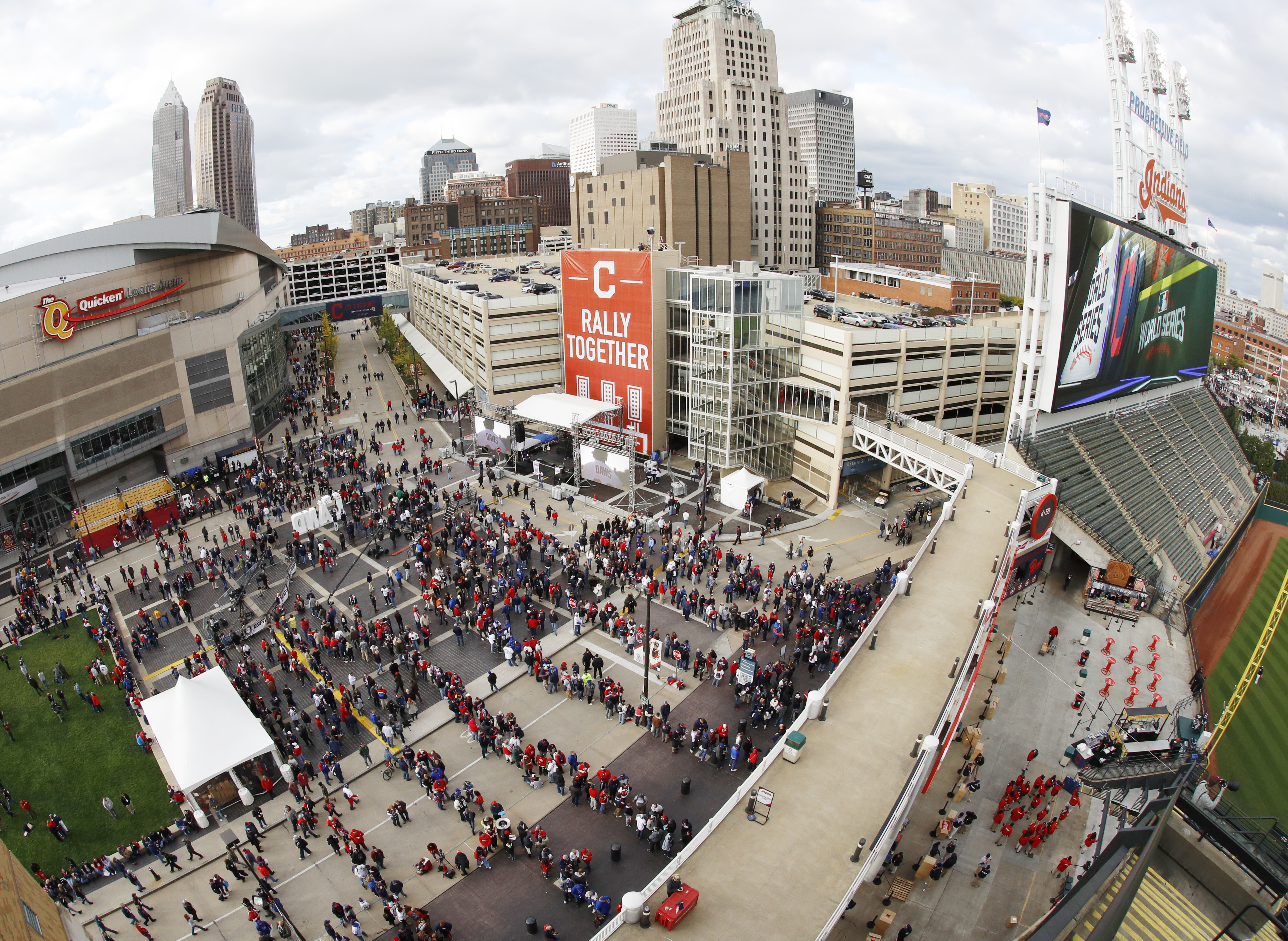 Fans line up for Game 1 of the Major League Baseball World Series at Progressive Field between the Cleveland Indians and the Chicago Cubs and the season opener for the Cleveland Cavaliers at the Quicken Loans Arena on Tuesday, Oct. 25, 2016, in Cleveland. (AP Photo/Gene J. Puskar)
