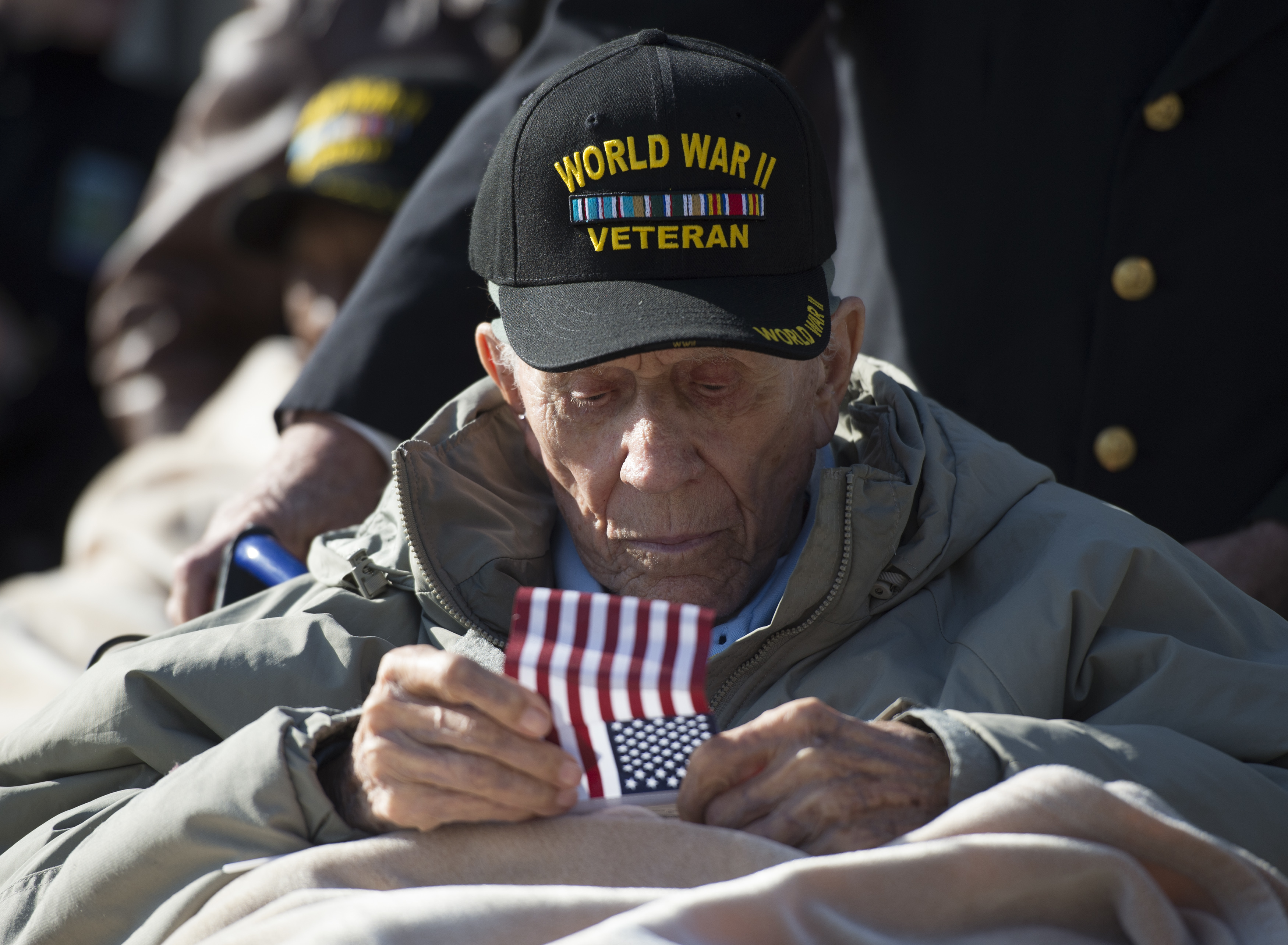 WWII veteran and Pearl Harbor survivor Casey Stevens waits to line to attend the Pearl Harbor 75th anniversary commemoration, Wednesday, Dec. 7, 2016, at the National World War II Memorial in Washington, in honor of the 2,403 men and women killed and the 1,178 wounded at Pearl Harbor 75 years ago. (AP Photo/Molly Riley)