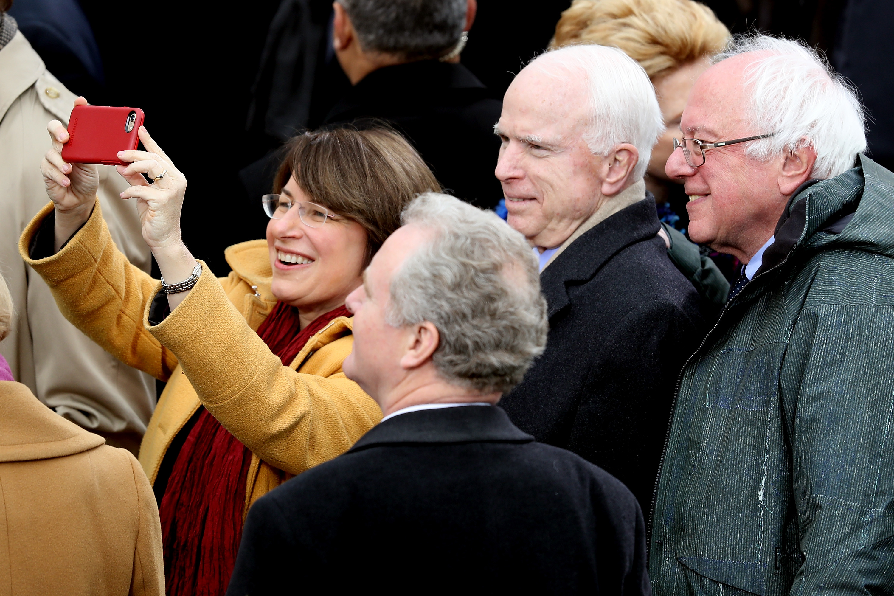 WASHINGTON, DC - JANUARY 20: Sen. Amy Klobuchar (D-MN) (L) takes a selfie with Sen. John McCain (R-AZ) and Sen. Bernie Sanders (D-VT) (R) on the West Front of the U.S. Capitol on January 20, 2017 in Washington, DC. In today's inauguration ceremony Donald J. Trump becomes the 45th president of the United States. (Photo by Joe Raedle/Getty Images)