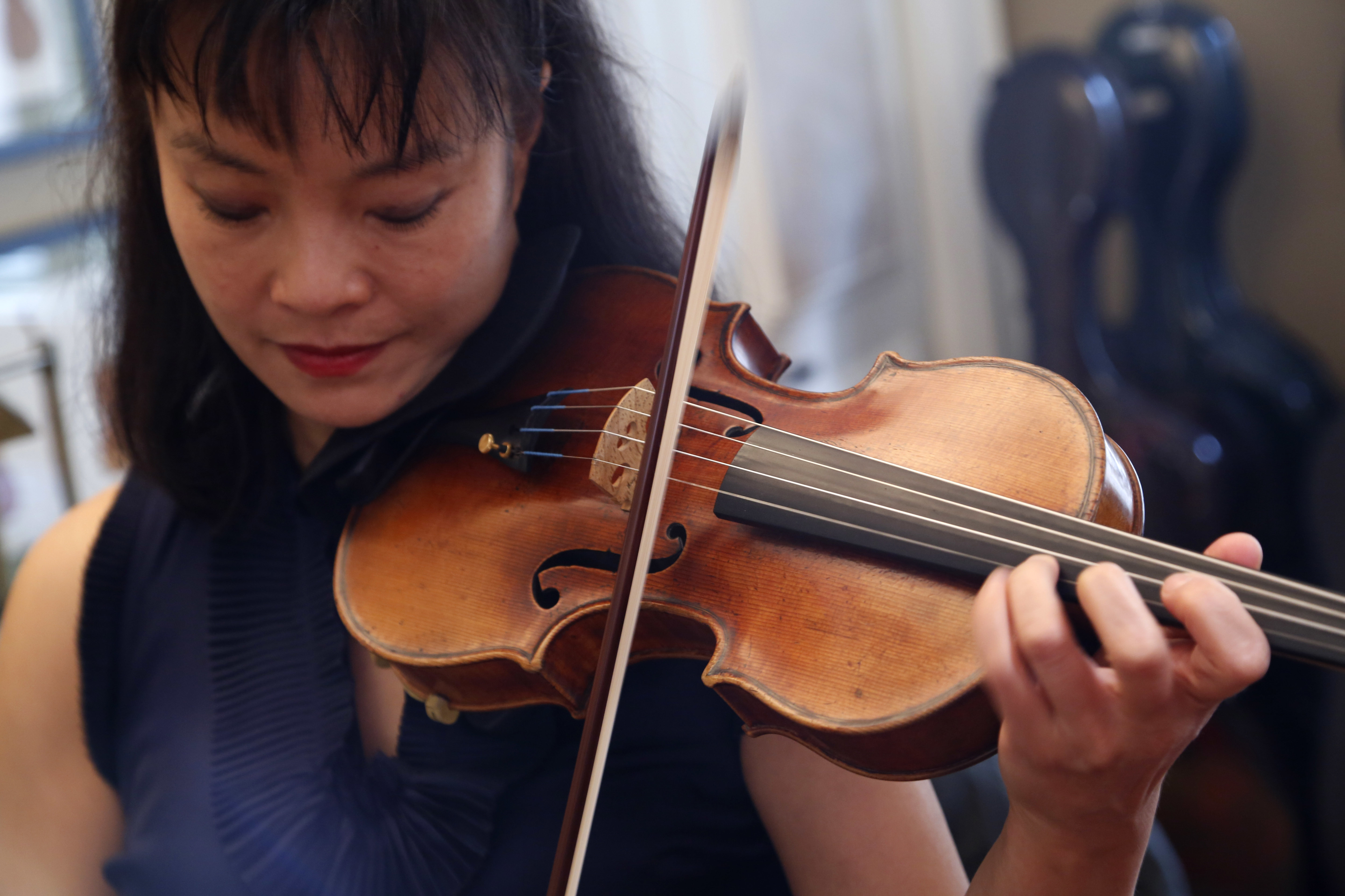 Mira Wang plays the Ames Stradivarius violin in New York, Wednesday, March 8, 2017. After a meticulous restoration that took more than a year, the Ames Stradivarius violin that was stolen from violinist Roman Totenberg is about to return to the stage. Wang, a former student of Totenberg's, will play the instrument at a private concert in New York on March 13. (AP Photo/Seth Wenig)