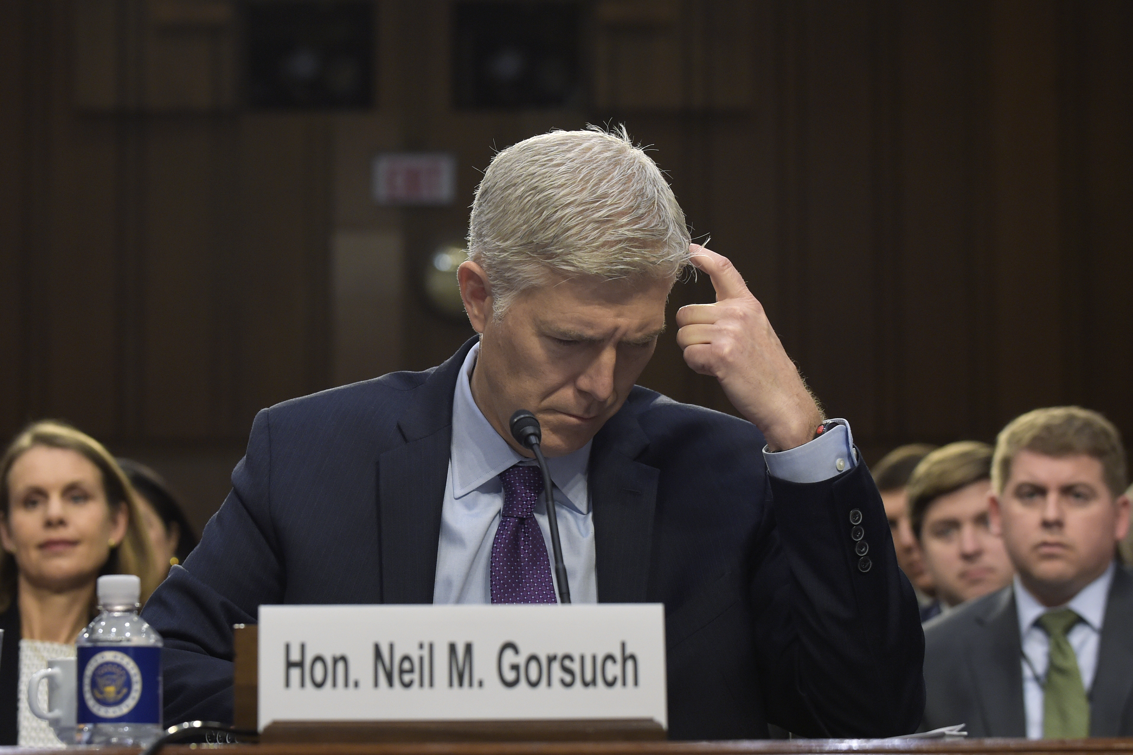 Supreme Court Justice nominee Neil Gorsuch looks over a document as he testifies on Capitol Hill in Washington, Tuesday, March 21, 2017, during his confirmation hearing before the Senate Judiciary Committee. (AP Photo/Susan Walsh)