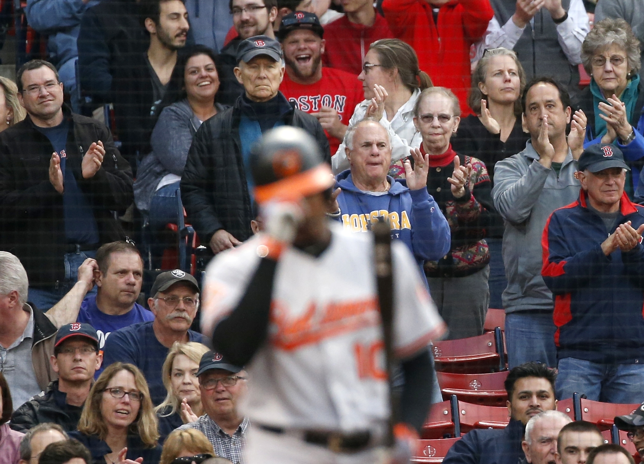 Fans give a standing ovation as Baltimore Orioles' Adam Jones comes to bat during the first inning of a baseball game, Tuesday against the Boston Red Sox, May 2, 2017, in Boston. (AP Photo/Michael Dwyer)